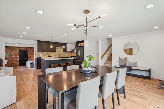 4634 W Tufts Cir, Denver, CO 80236 - dining space featuring stairway, light wood-style floors, a chandelier, and recessed lighting