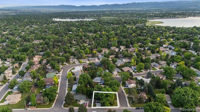 4634 W Tufts Cir, Denver, CO 80236 - aerial view of residential area with a water and mountain view and property boundaries highlighted