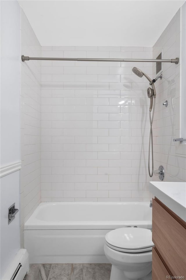 full bathroom featuring tile patterned floors, baseboard heating, tiled shower / bath combo, and toilet