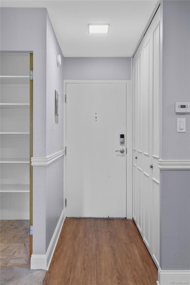 corridor with light hardwood / wood-style flooring