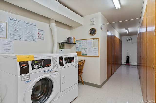 washroom featuring light tile patterned floors, a baseboard heating unit, and washer and clothes dryer