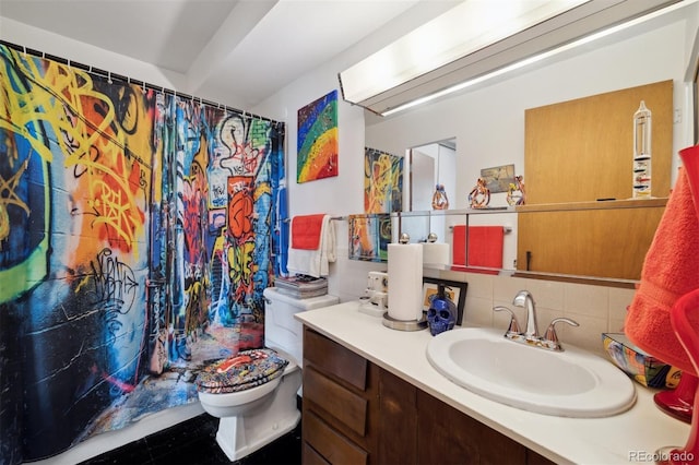 bathroom with tasteful backsplash, vanity, and toilet