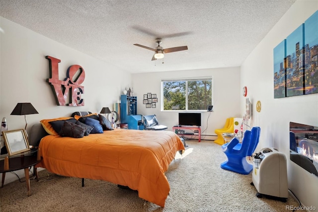 bedroom with ceiling fan, carpet, and a textured ceiling