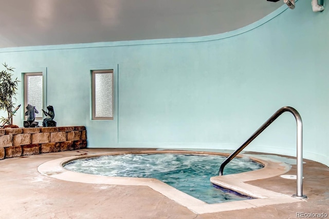 view of swimming pool with an indoor hot tub