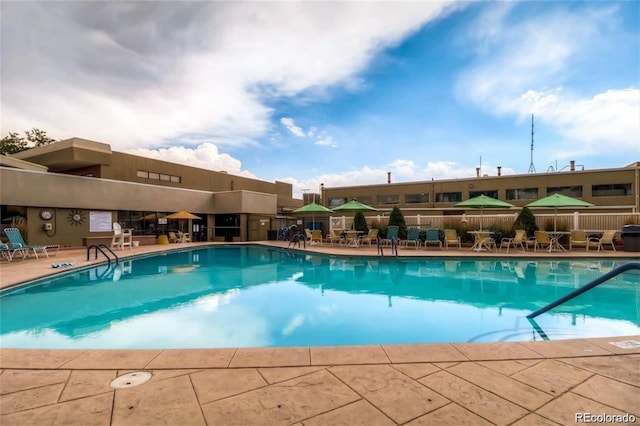 pool featuring a patio area and fence