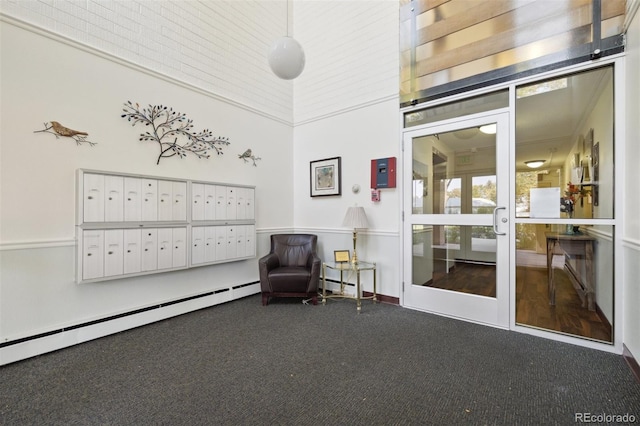 living area featuring baseboard heating, carpet, and mail area