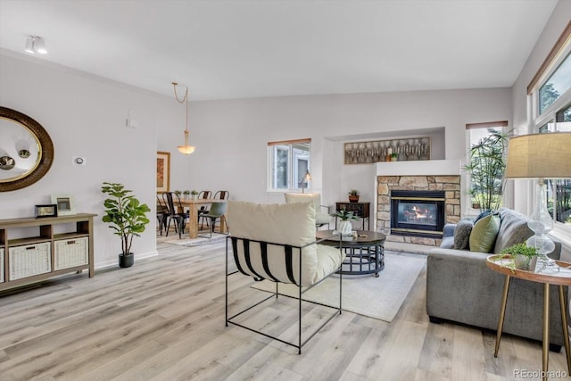 11585 Decatur St Unit B, Denver, CO 80234 - living area with wood finished floors, a stone fireplace, and baseboards