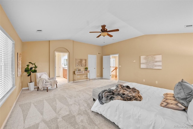 18967 W 54th Ln, Golden, CO 80403 - carpeted bedroom with lofted ceiling, arched walkways, multiple windows, ceiling fan, and ensuite bath