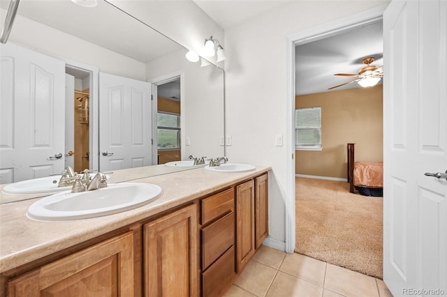 18967 W 54th Ln, Golden, CO 80403 - full bath featuring double vanity, tile patterned flooring, healthy amount of natural light, and a ceiling fan