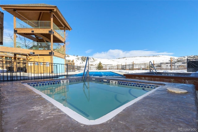 snow covered pool featuring a mountain view