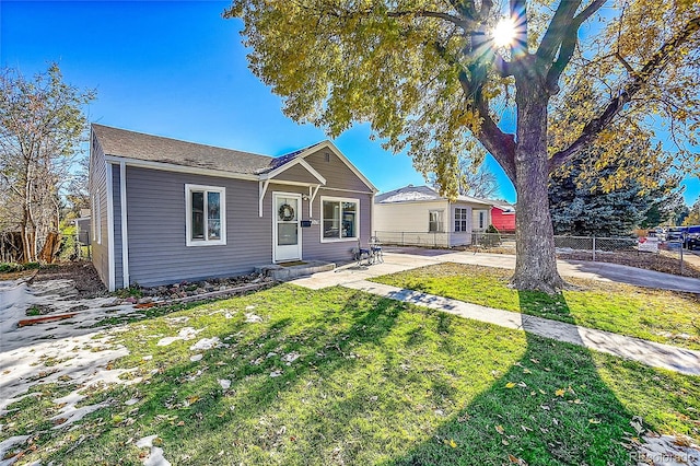 ranch-style house featuring a front yard and a patio