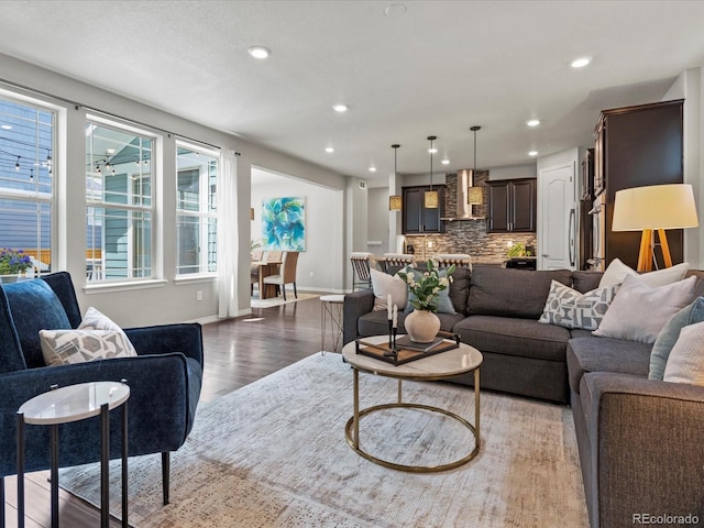 5445 Verbena St, Denver, CO 80238 - living area featuring light wood finished floors and recessed lighting