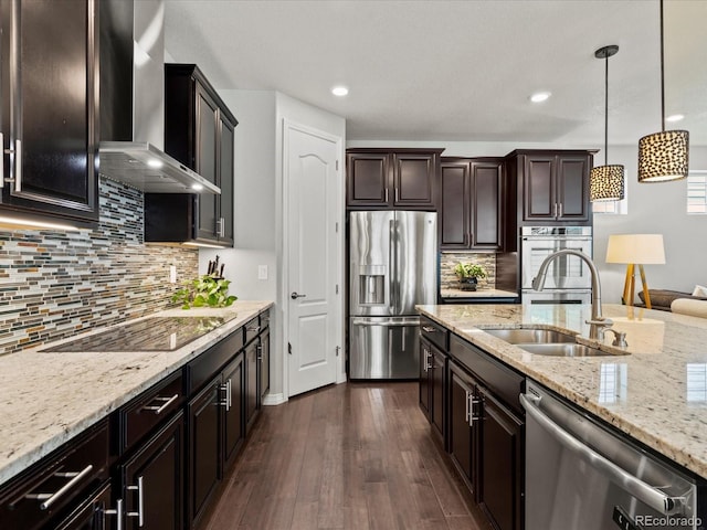 5445 Verbena St, Denver, CO 80238 - kitchen featuring stainless steel appliances, wall chimney range hood, dark wood-style floors, hanging light fixtures, and light stone countertops