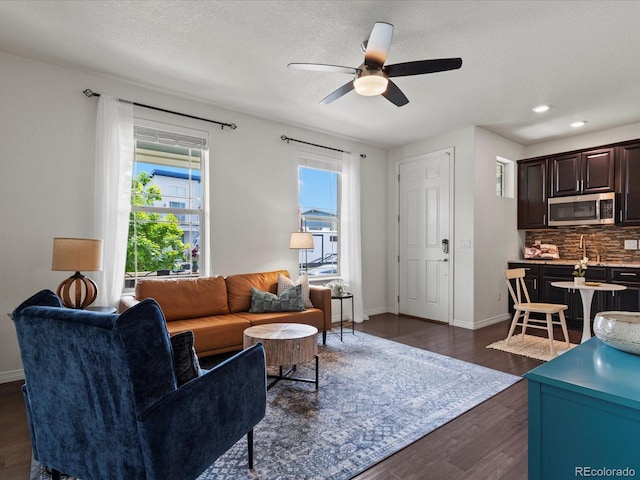 5445 Verbena St, Denver, CO 80238 - living room with dark wood finished floors, ceiling fan, a textured ceiling, and recessed lighting