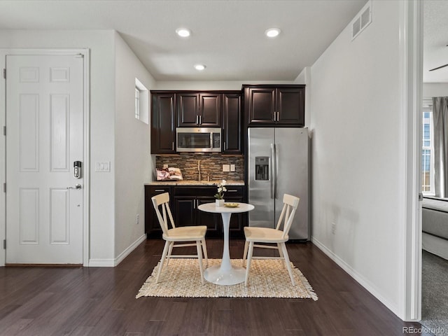 5445 Verbena St, Denver, CO 80238 - kitchen featuring stainless steel appliances, tasteful backsplash, dark wood-style flooring, dark brown cabinets, and recessed lighting