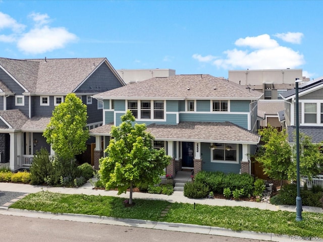 5445 Verbena St, Denver, CO 80238 - view of front of home with a porch, brick siding, and a shingled roof