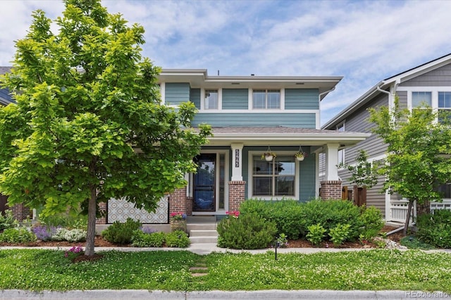 5445 Verbena St, Denver, CO 80238 - view of front facade featuring brick siding and a front lawn
