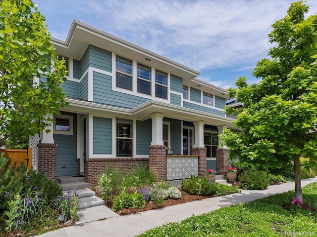 5445 Verbena St, Denver, CO 80238 - view of front facade with brick siding and covered porch