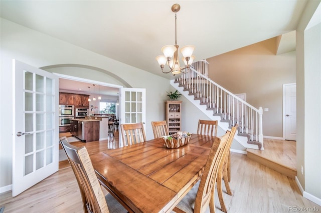 9548 La Quinta Dr, Lone Tree, CO 80124 - dining area featuring a chandelier, light wood-type flooring, stairs, and baseboards