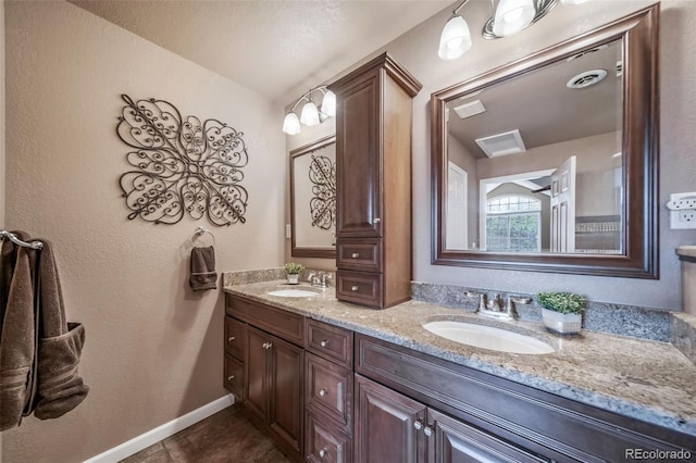 9548 La Quinta Dr, Lone Tree, CO 80124 - bathroom with double vanity, baseboards, and tile patterned floors