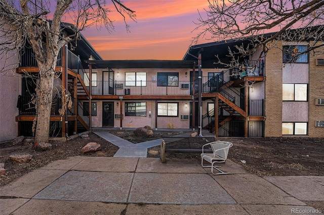 back house at dusk with a patio area