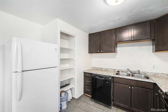 kitchen with black dishwasher, sink, white refrigerator, light tile patterned floors, and dark brown cabinetry