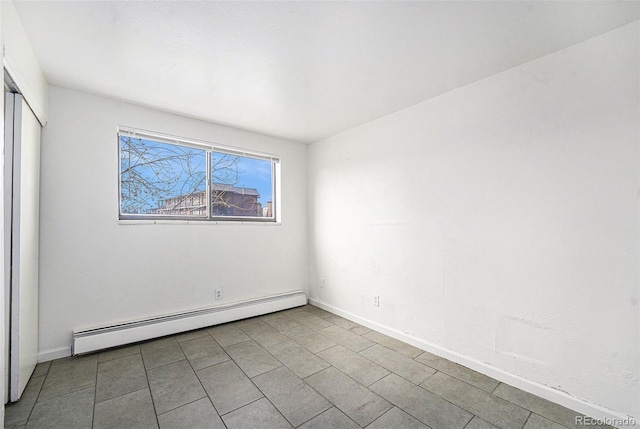 spare room with light tile patterned floors and baseboard heating