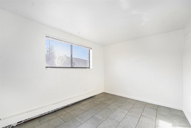 empty room featuring a baseboard radiator and tile patterned flooring