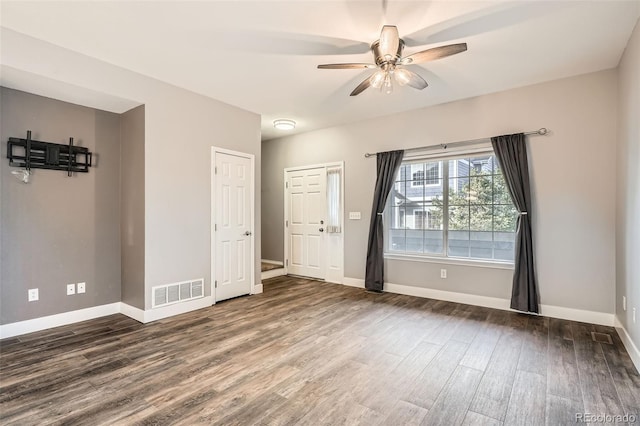 empty room featuring ceiling fan and dark hardwood / wood-style floors