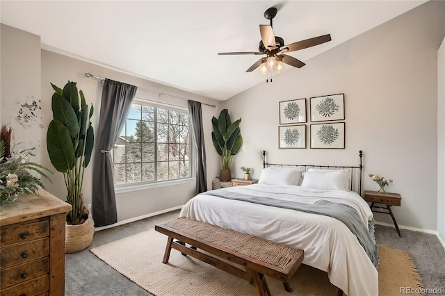 carpeted bedroom featuring lofted ceiling and ceiling fan