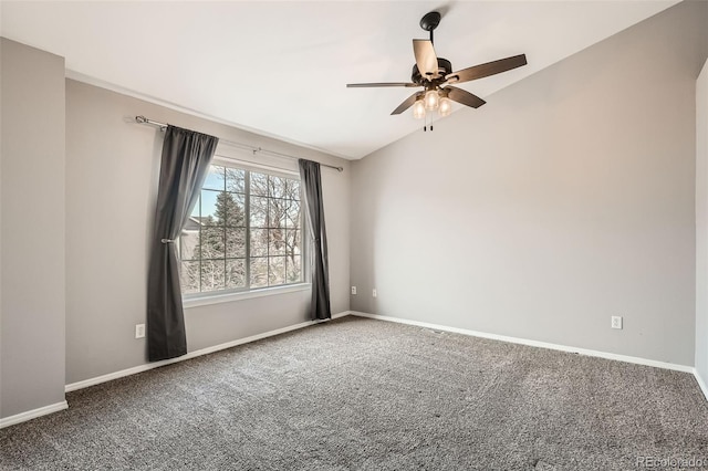 carpeted spare room with vaulted ceiling and ceiling fan