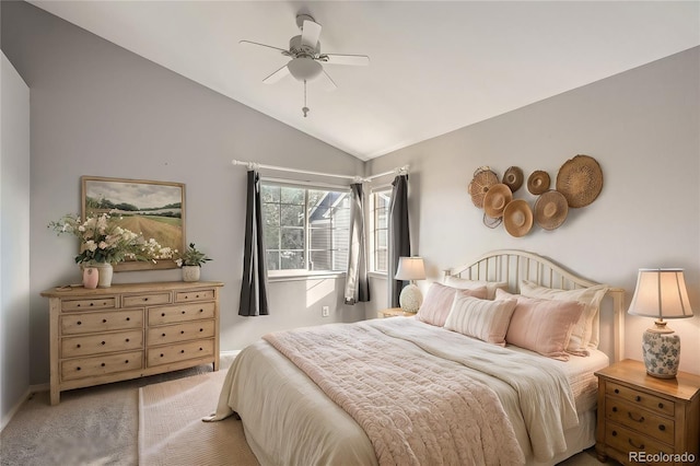 carpeted bedroom with ceiling fan and lofted ceiling