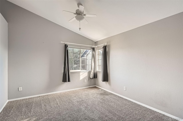 unfurnished room with ceiling fan, vaulted ceiling, and carpet flooring