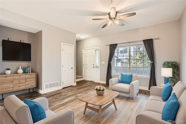 living room featuring ceiling fan and hardwood / wood-style flooring