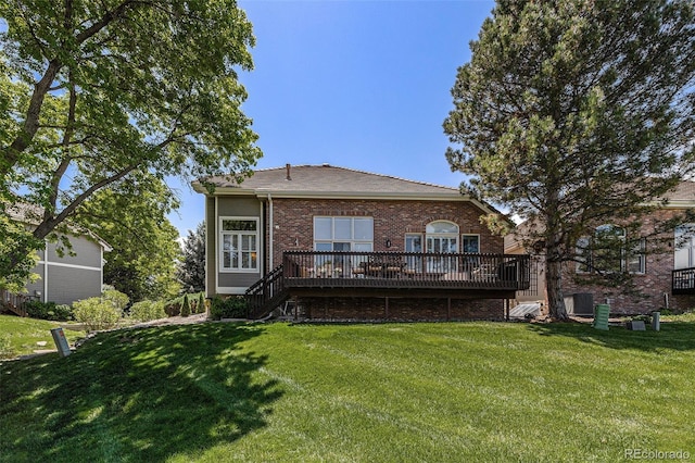 6500 W Mansfield Ave Unit 39, Denver, CO 80235 - rear view of property featuring a wooden deck, a yard, brick siding, and stairs