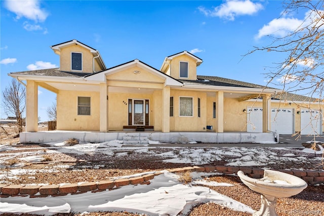 view of front of home featuring covered porch and a garage