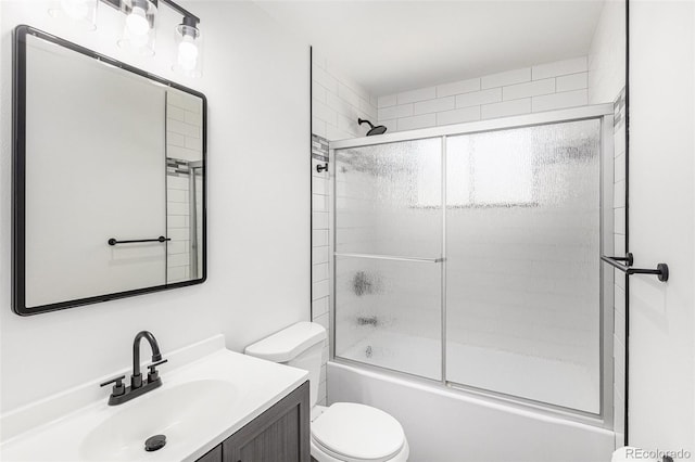 full bathroom with shower / bath combination with glass door, vanity, and toilet