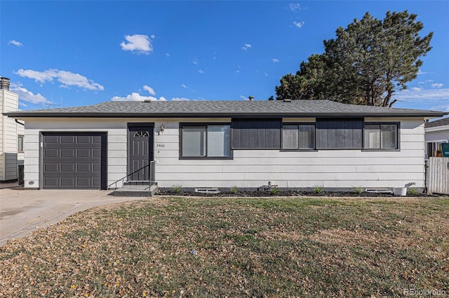 ranch-style home featuring a garage and a front yard