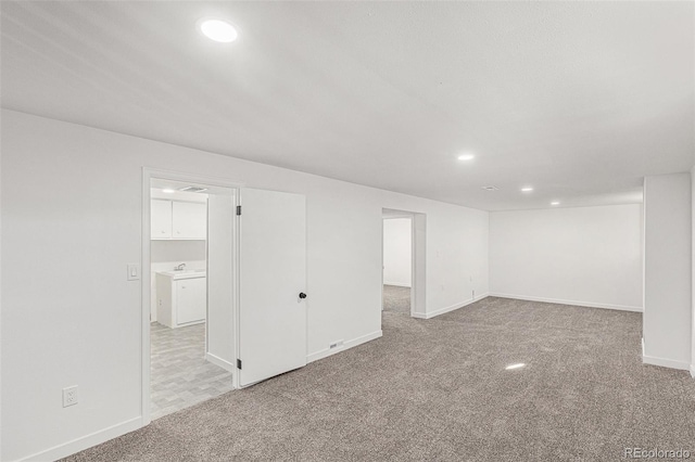 unfurnished room with light colored carpet