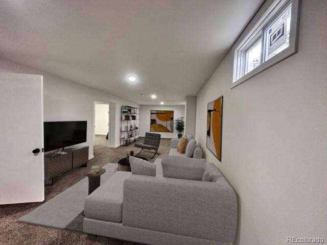 living room with vaulted ceiling and carpet floors