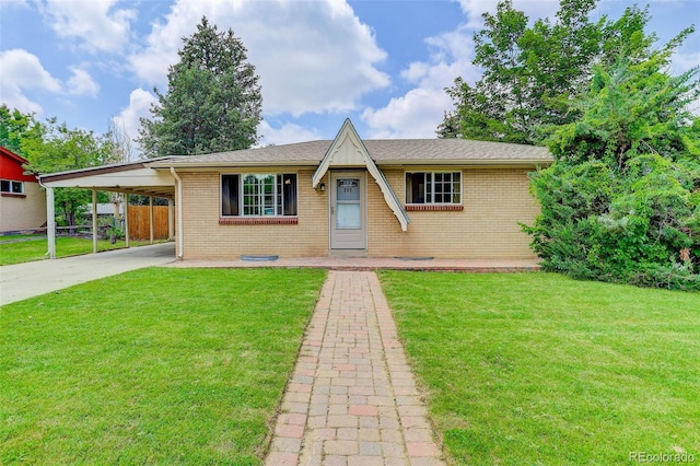 609 S Quentin St, Aurora, CO 80012 - view of front of home with brick siding, driveway, and an attached carport