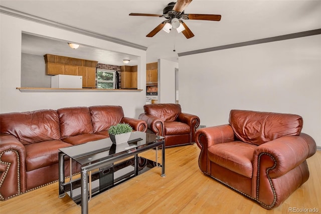 609 S Quentin St, Aurora, CO 80012 - living area with ceiling fan, light wood-style floors, and crown molding