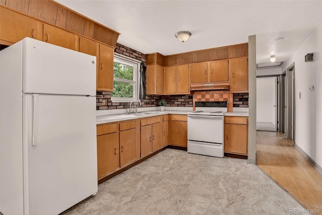 609 S Quentin St, Aurora, CO 80012 - kitchen with white appliances, under cabinet range hood, light countertops, and decorative backsplash