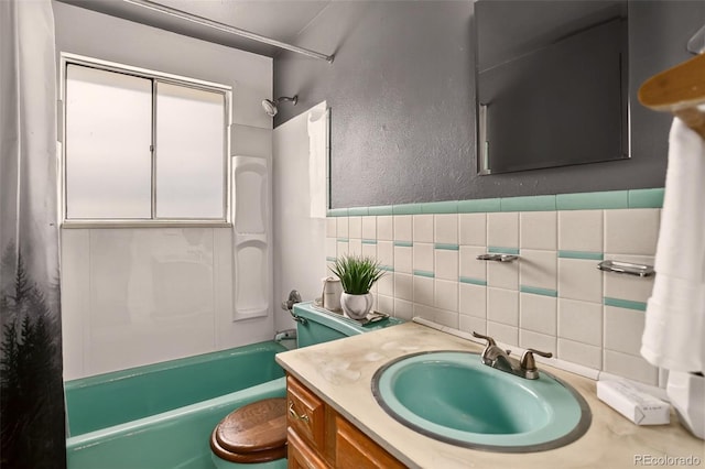 609 S Quentin St, Aurora, CO 80012 - full bathroom with shower / bath combo, vanity, backsplash, tile walls, and a textured wall