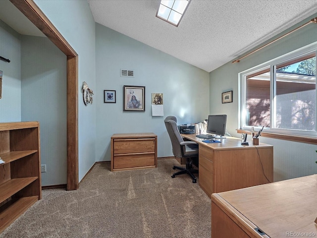 carpeted home office featuring a textured ceiling and lofted ceiling