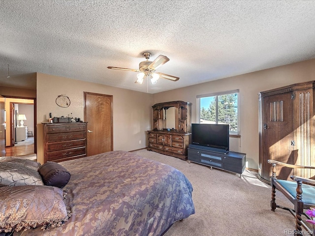 carpeted bedroom with ceiling fan and a textured ceiling