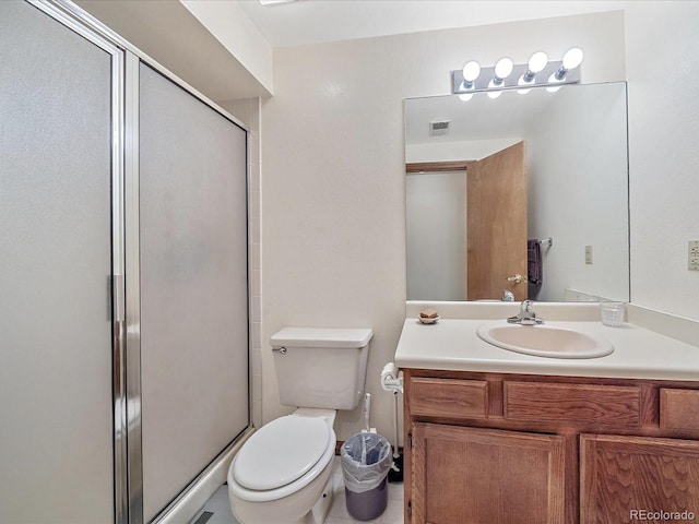 bathroom with tile patterned floors, vanity, toilet, and an enclosed shower