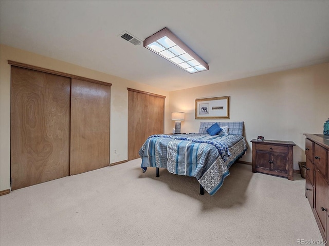 carpeted bedroom with multiple closets