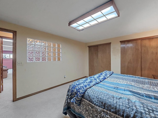 carpeted bedroom with multiple closets