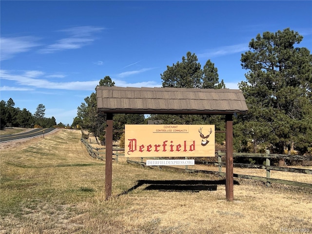 community sign featuring a lawn